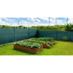 Anthracite-colored masking net placed on a mesh fence, visible vegetable boxes.