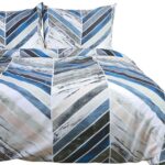 Interior with white bed linen on the sofa. Bedroom with bed, white bedding, and bedside table. White pillows, duvet and duvet case on bed with blue headboard. Front view.