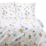 Minimalist beige boho bedroom with empty whate wall for mockups. Wooden double bed with pillows, cozy furniture. Room interior with copyspace.