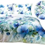 Minimalist bedroom with a plush white bed covered in a soft blue