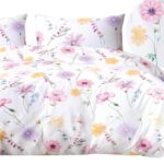 front view of a mockup white bed with a white blanket in a luxur