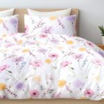 front view of a mockup white bed with a white blanket in a luxur